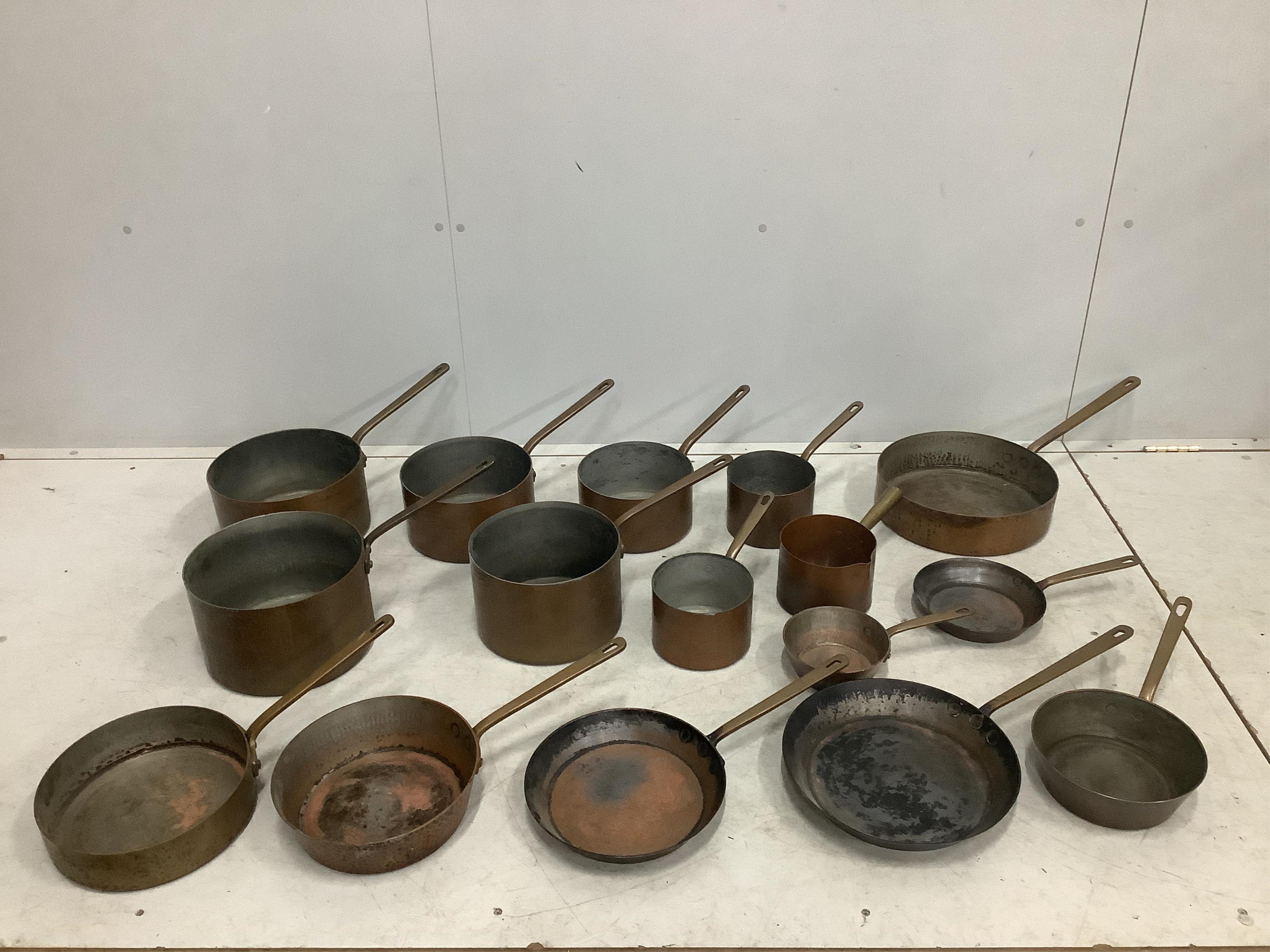 A quantity of assorted copper pans and covers. Condition - fair